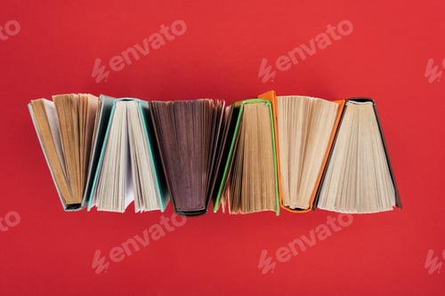 Preview: Top view of hardcover books on red surface