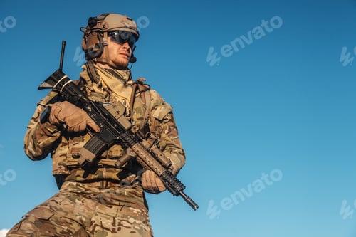 Preview: Soldier Holding Rifle Against a Clear Blue Sky