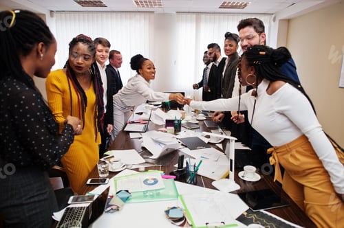 Preview: Multiracial young creative people in modern office