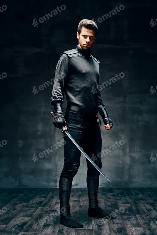 Preview: Full length portrait of warrior man posing with a sword