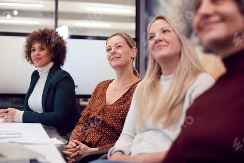Preview: Line Of Businesswomen In Modern Office Listening To Presentation By Colleague