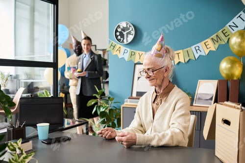 Preview: Senior Caucasian Woman Sitting at Desk Smiling during Retirement Celebration