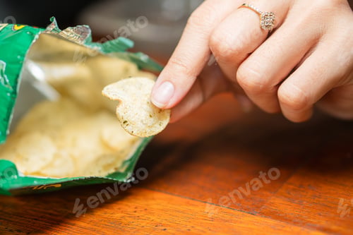 Preview: Open Bag of Potato Chips on Wooden Table