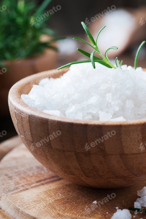 Preview: White salt and green rosemary on the wooden table