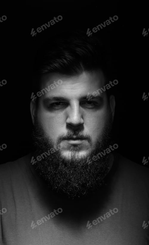 Preview: Serious Portrait Of Men In Darkness. Black Background.