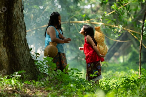 Preview: Two girls Asian women with traditional clothing stand in the rainforest.