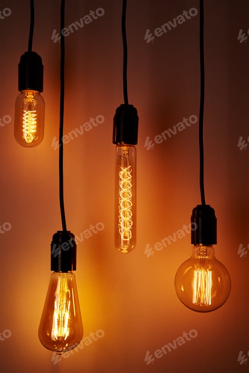 Preview: Set of a vintage light bulb on orange background. Glowing edison bulb