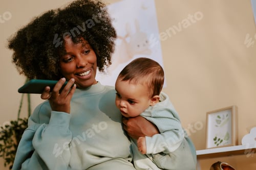 Preview: African American Mom Listening to Voice Message with Her Baby