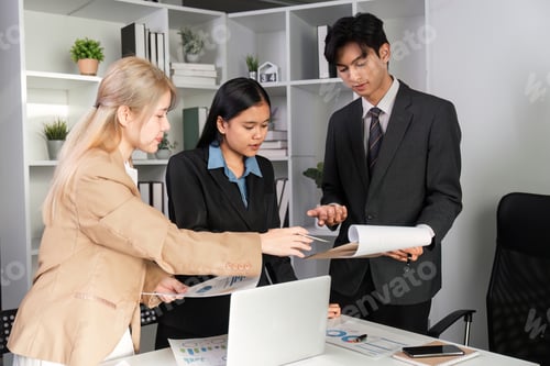 Preview: Business Team Collaborating on Data Analysis with Graphs in a Modern Office Setting