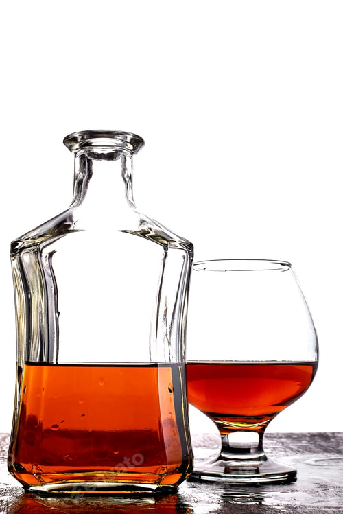 Preview: Glass of splash whiskey with bottle.