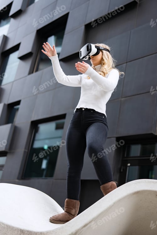 Preview: Woman Wearing Virtual Reality Glasses In Front Of Futuristic City Building Wall