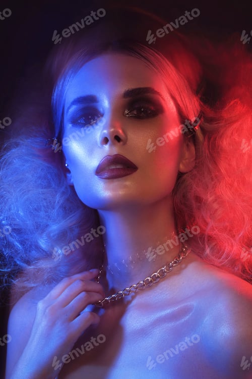 Preview: Portrait of a beautiful woman with bright evening makeup and colored filters.