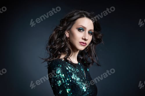 Preview: Beauty portrait of a woman with beautiful evening makeup, a brunette girl in a shiny evening dress