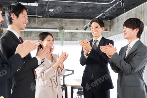 Preview: Asian business person applauding with his team