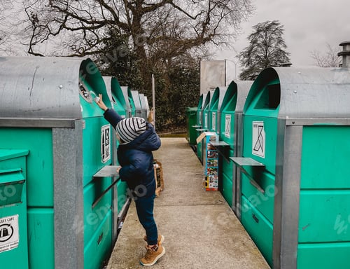 Preview: Little child throwing plastic bottle into recycling bin. Waste sorting education concept