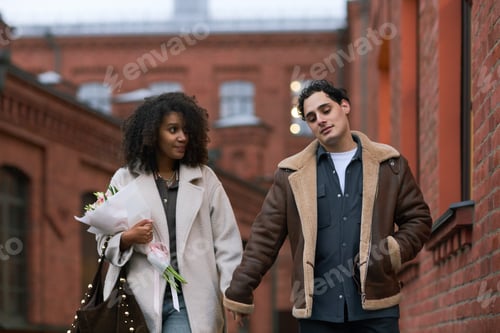 Preview: Young Multiethnic Couple Walking Together Outdoors during Romantic Date