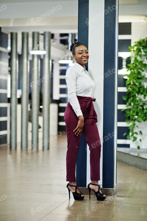 Preview: African woman in dress posing at restaurant