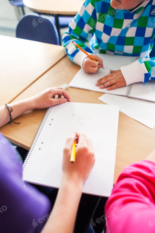 Preview: Cropped image of junior high students studying at desk in classroom