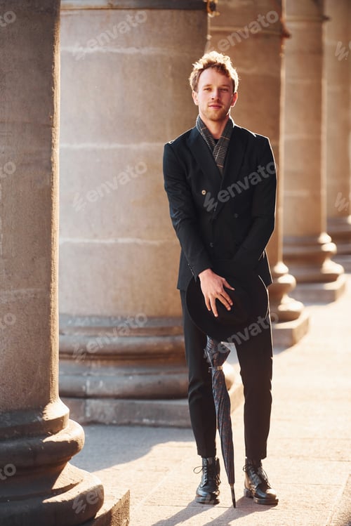 Preview: Elegant young man in formal classy clothes outdoors in the city