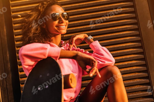 Preview: Smiling Woman Poses with a Skateboard Outside