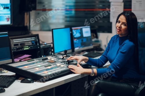 Preview: Middle aged woman using equipment in control room on a tv station