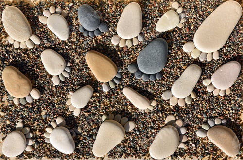 Preview: Footprints from pebble stones on sandy beach