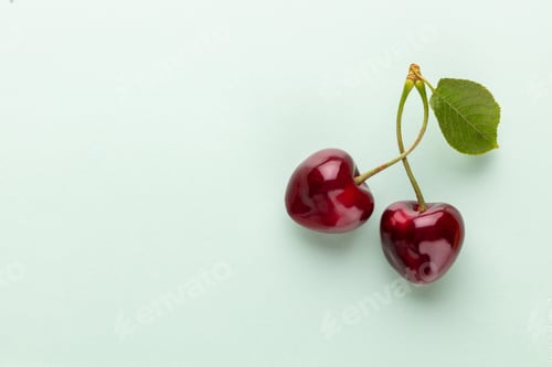 Preview: Cherry berries on a pastel background top view. Background with a cherry on a sprig, flat lay