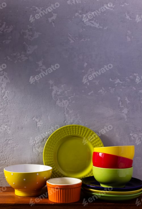 Preview: Empty colorful crockery or ceramic dishes set. White kitchen dishware and tableware on wooden table