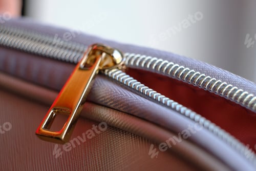 Preview: Selective focus, yellow metal zipper of a makeup bag or small purse macro pattern background