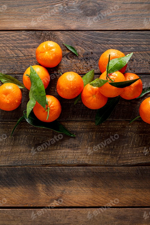 Preview: Tangerines, fresh mandarin oranges, clementines with leaves on wooden background