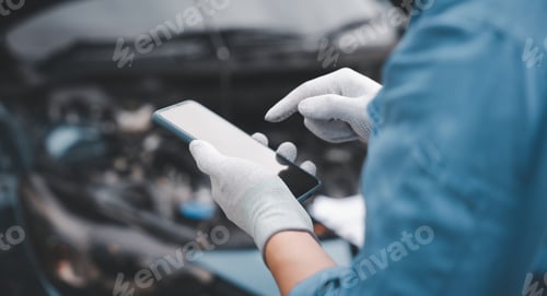 Preview: Mechanic use smartphone repair car.