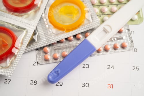 Preview: Pregnancy test and birth control pills on calendar, contraception health and medicine.