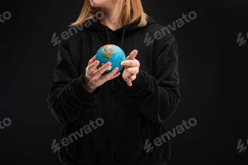 Preview: Cropped view of woman holding plasticine globe isolated on black, global warming concept