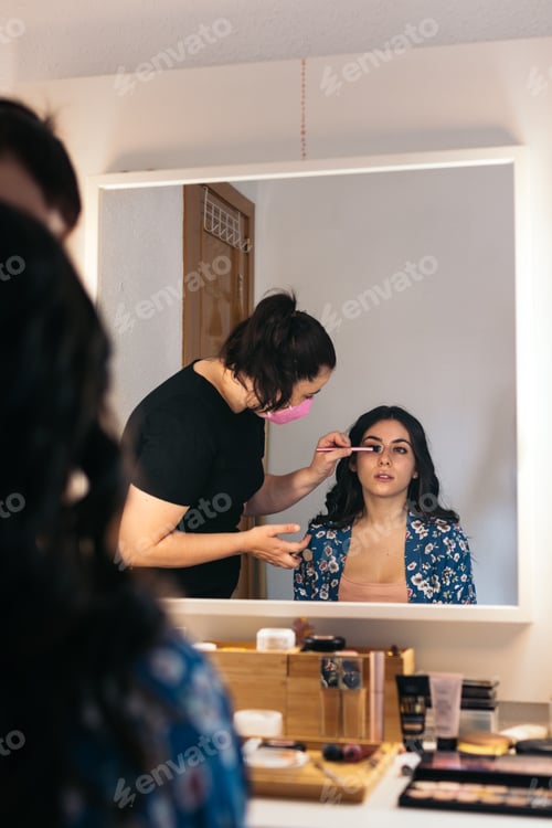 Preview: Bride being made up by a professional makeup artist