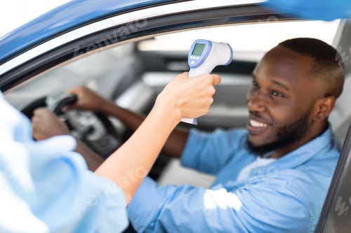 Preview: Medical Worker Checking Body Temperature Of Black Man In Car