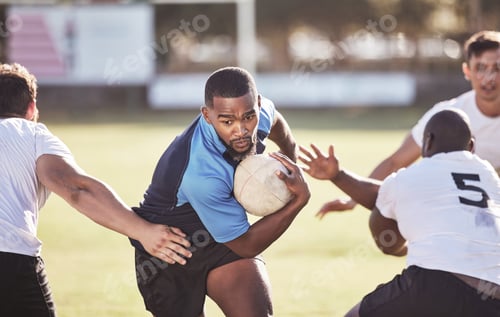 Preview: African american rugby player running away from an opponent while attempting to score a try during