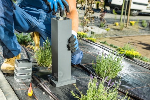 Preview: Landscaping Worker Installing Backyard Lighting