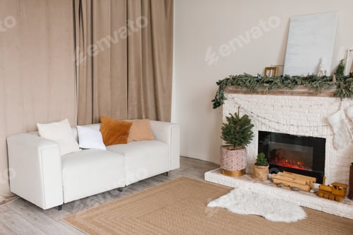 Preview: Living room with a white couch and a fireplace. Cozy apartment and warm atmosphere for Christmas