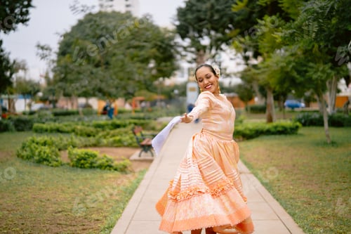 Preview: Young latin woman dancing peruvian marinera in the park