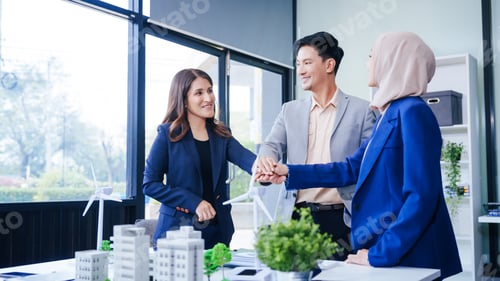 Preview: Three business people gather at a desk, unit with joined hands sustainable solutions for a cleaner