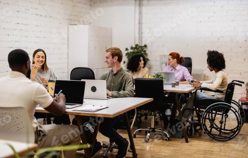 Preview: Diverse coworkers collaborating in modern inclusive office