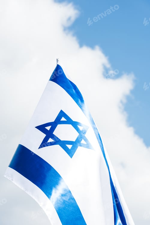 Preview: low angle view of national israel flag with blue star of david against sky with clouds