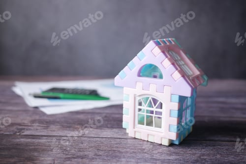 Preview: the concept of finance concept with model house and paper