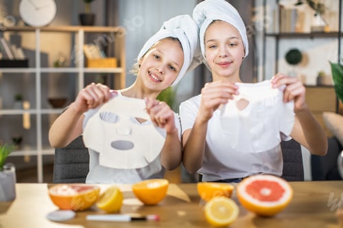Preview: Two sisters holding vitamin mask for face at desk