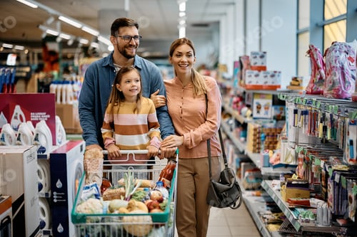 Preview: Happy family looking for school supplies while shopping in supermarket.
