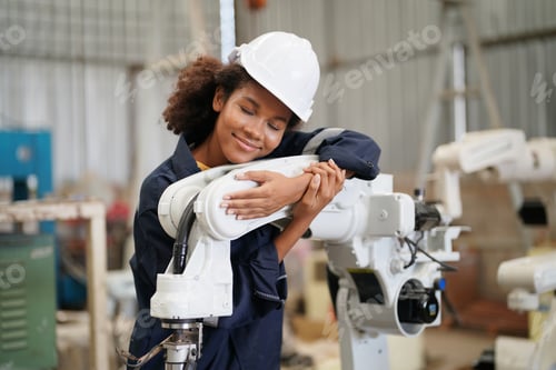 Preview: Robotics engineer operating robot aided CNC machine in robotics research facility