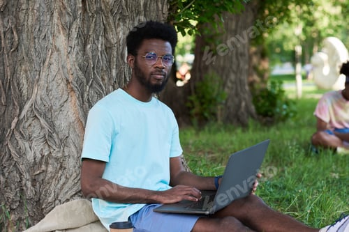 Preview: Student studying outdoors