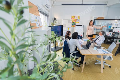 Preview: Business Professionals Discussing Project in Modern Office