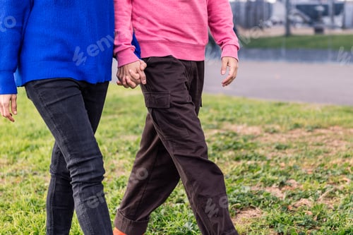 Preview: two people walking together holding hands