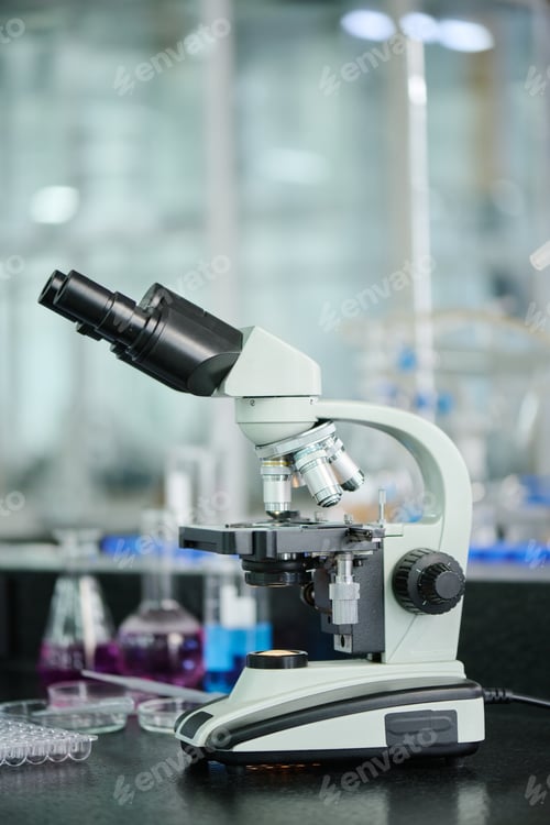 Preview: Microscope standing against glassware